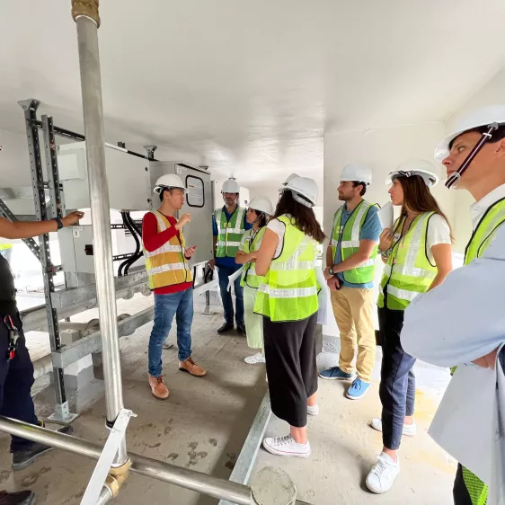Photo of a visit by interns to one of the various edpr apac projects. In the photograph we can see several people in vests and protective helmets.
